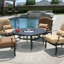 Four patio chairs surrounding metal table with ice bucket in centre